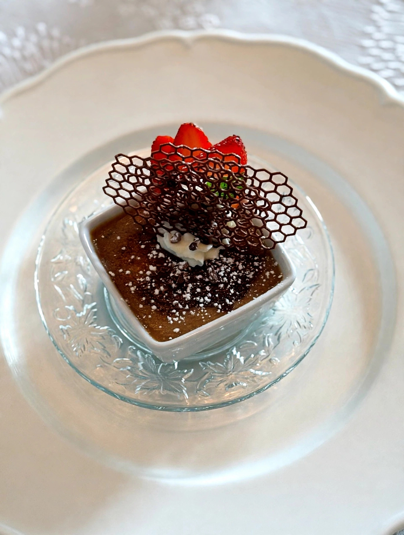 Chocolate pot de crème with chocolate tuile and strawberries
