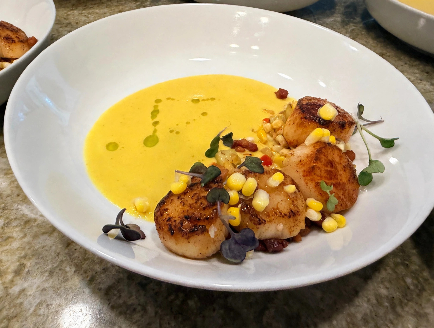 Seared scallops with sweet corn, microgreens and golden corn purée