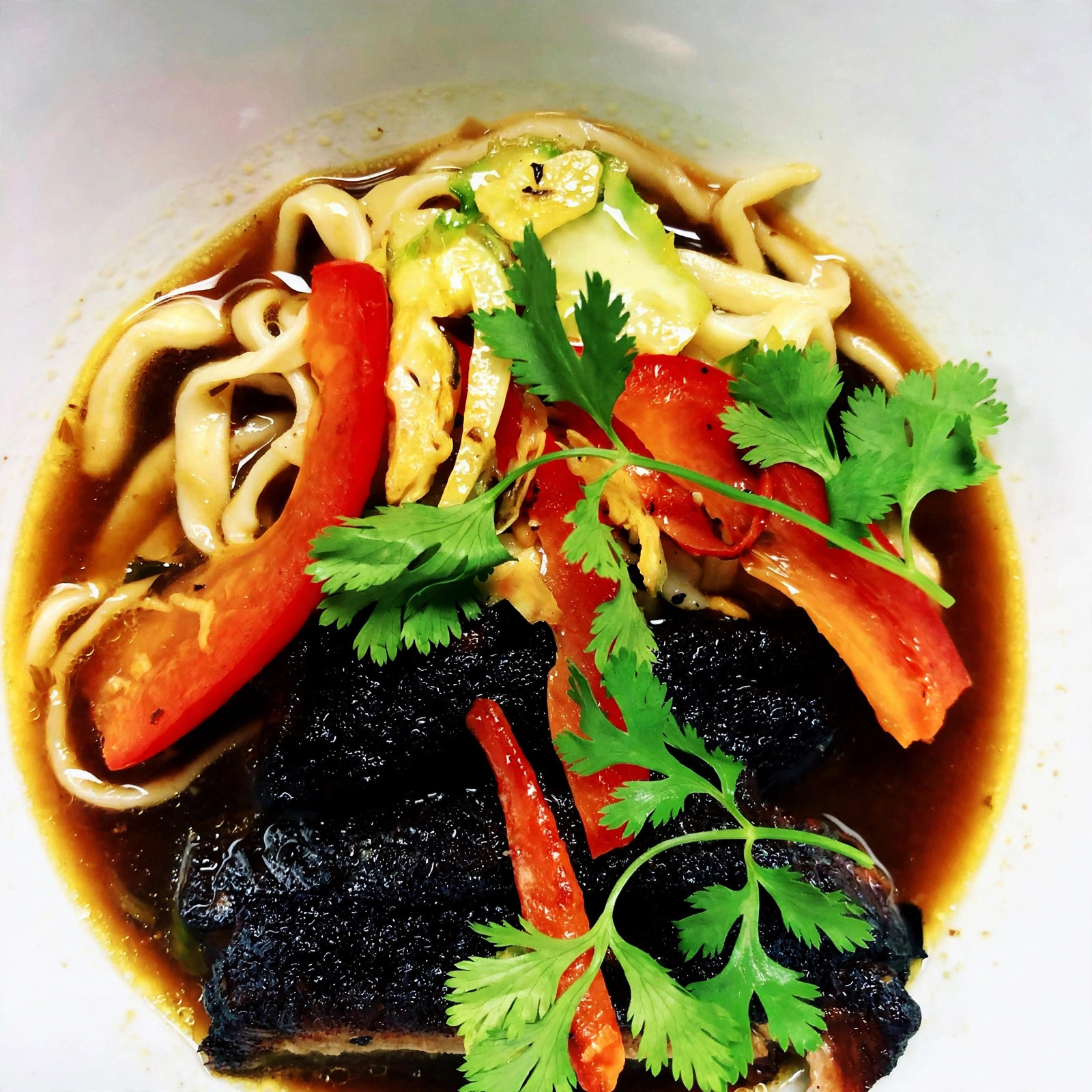 Braised short rib noodle bowl with peppers and cilantro
