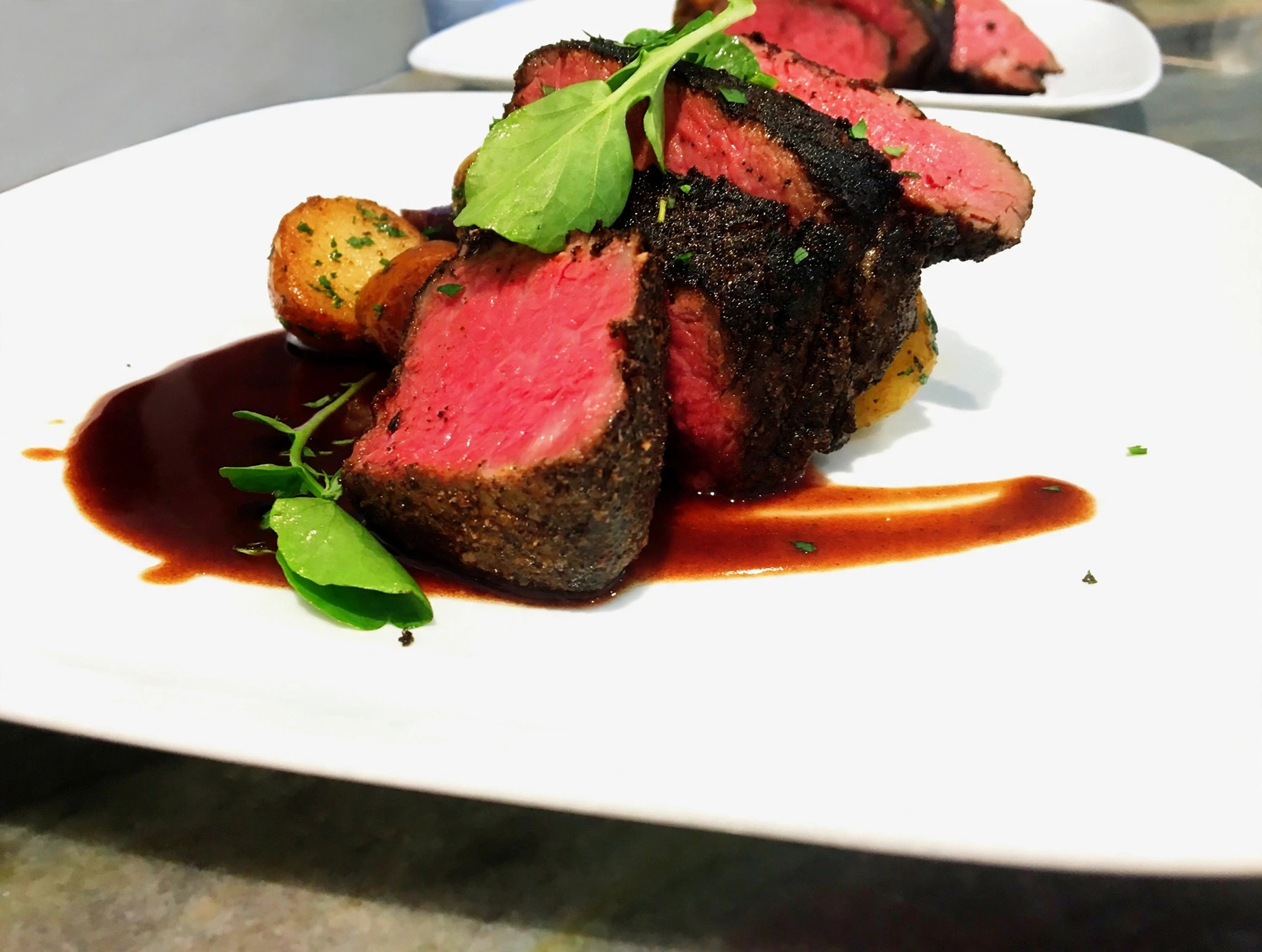 Sliced beef tenderloin with red wine jus