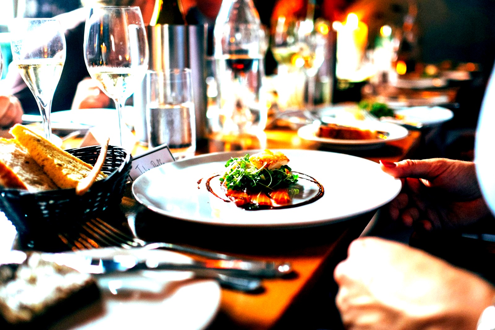 Dark elegant table setting with wine