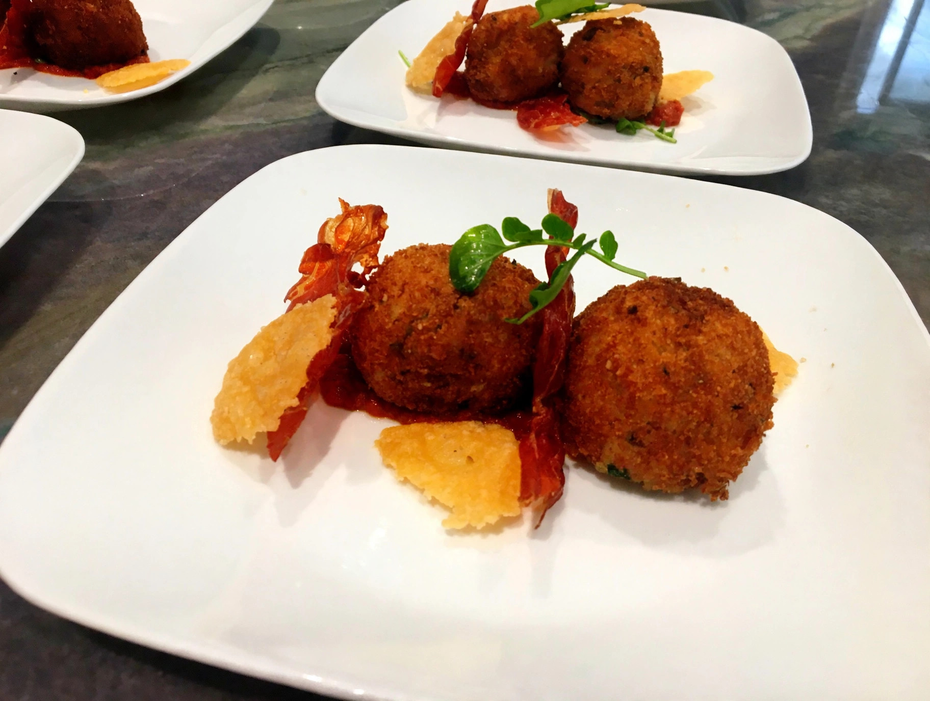 Arancini with crispy prosciutto and parmesan crisps