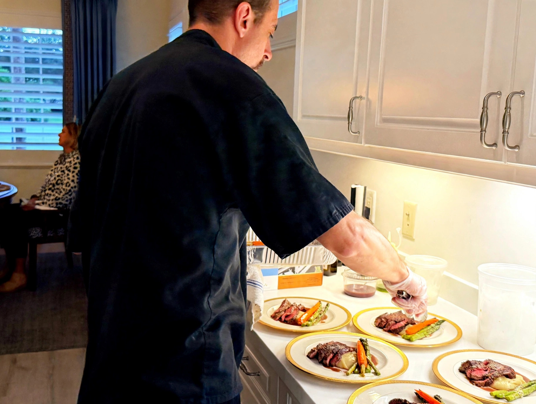 Chef Tony plating dishes in a client's kitchen